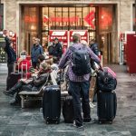 person standing beside the luggage bags