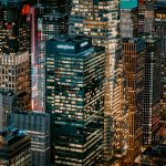 a view of a city at night from the top of a skyscraper